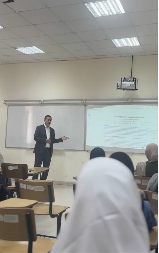 The instructor explains a cybersecurity topic using a projected presentation.